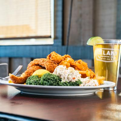 Fried Pick Two plate with Flounder And Shrimp, served with a glass of beer.