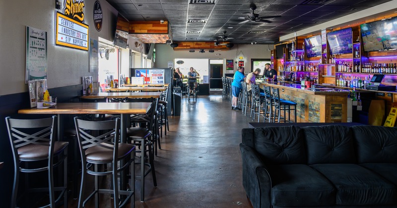 Interior,diner tables, chairs, bar, couch in front