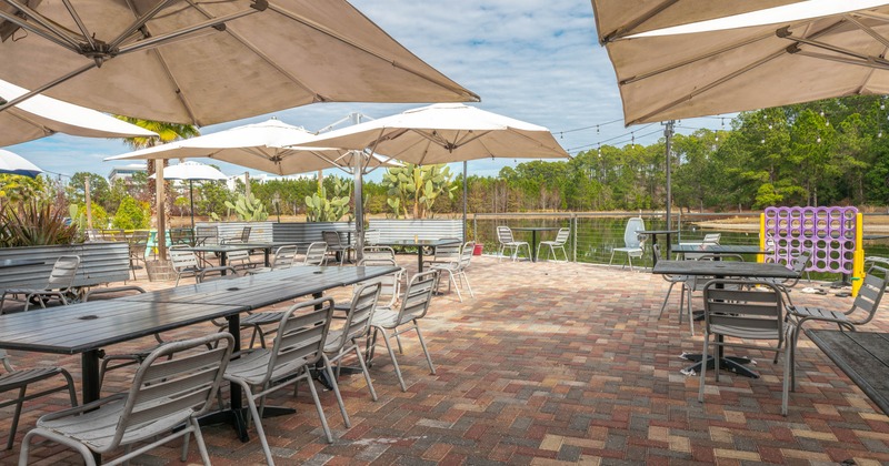 Outdoor patio with tables, chairs, umbrellas