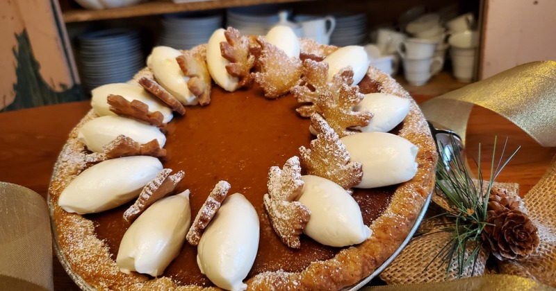 Gingersnap pumpkin pie with whipped cream dollops and cookies