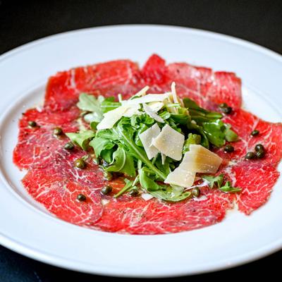 Beef Carpaccio, with arugula, cheese, and capers.