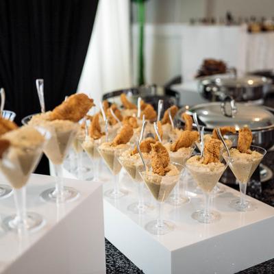Crispy fried chicken  served in plastic martini glasses.