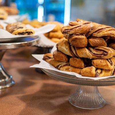 A display of assorted pastries stacked on stands.