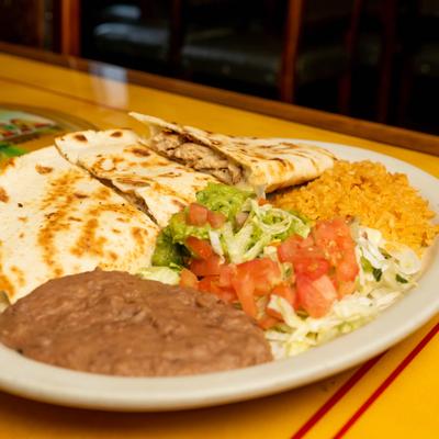 Chicken quesadilla served with refried beans, rice, guacamole and fresh salsa.