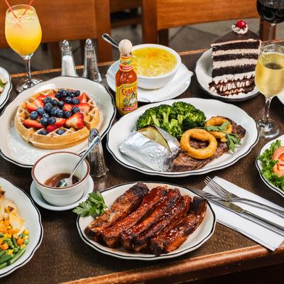 A table set with diverse foods and drinks.