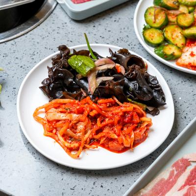 Selection of side dishes and ingredients for a hot pot.