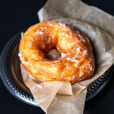 Doughnut on a paper-lined plate.