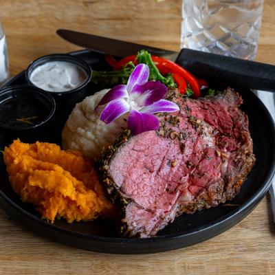 Prime rib served with mashed potatoes, salad and dipping sauces.