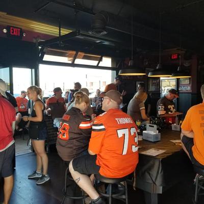 Fans at the tables sitting and watching the game