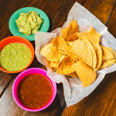 Fried corn tortilla chips served with two distinct salsas and guacamole.
