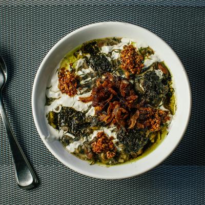 Persian soup with vegetables, noodles, beans, and whey.