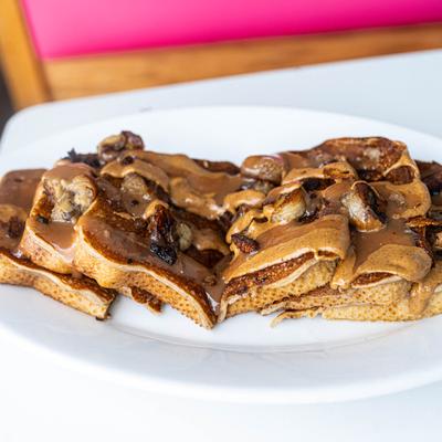 Vegan French toast with caramelized bananas, vegan caramel, almond butter, vegan bacon.