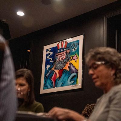 People, a frame on the wall behind them.