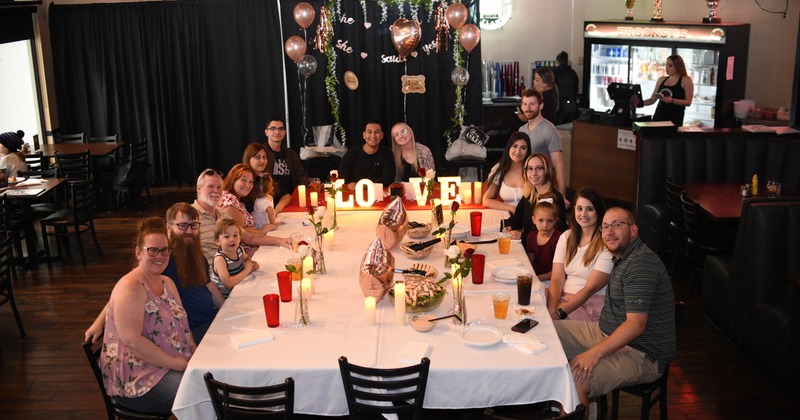 Interior, group of guest seating at big table