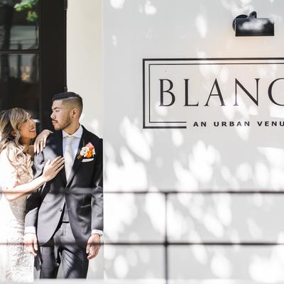 The bride and groom outside of the venue's entrance.