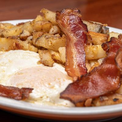 Fried eggs, with turkey bacon, and home fries.