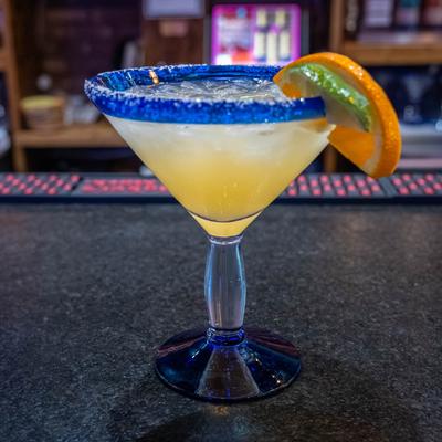 Margarita with salt rim and lime and orange garnish.