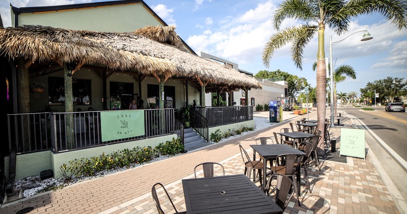Restaurant exterior, tables and chairs in front of the entrance