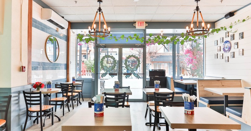 Light interior seating area with tables, chairs and booths