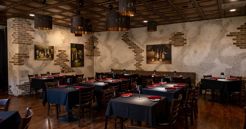 Interior dining room with black tablecloths and exposed brick accents