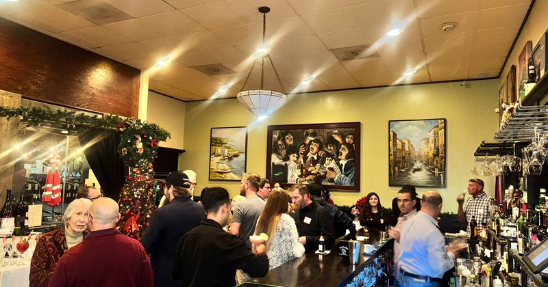 Interior, crowded bar area, room garnished with Christmas decorations