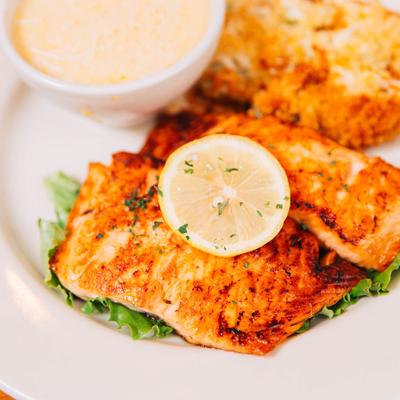 Honey Salmon served with creamy Parmesan grits.