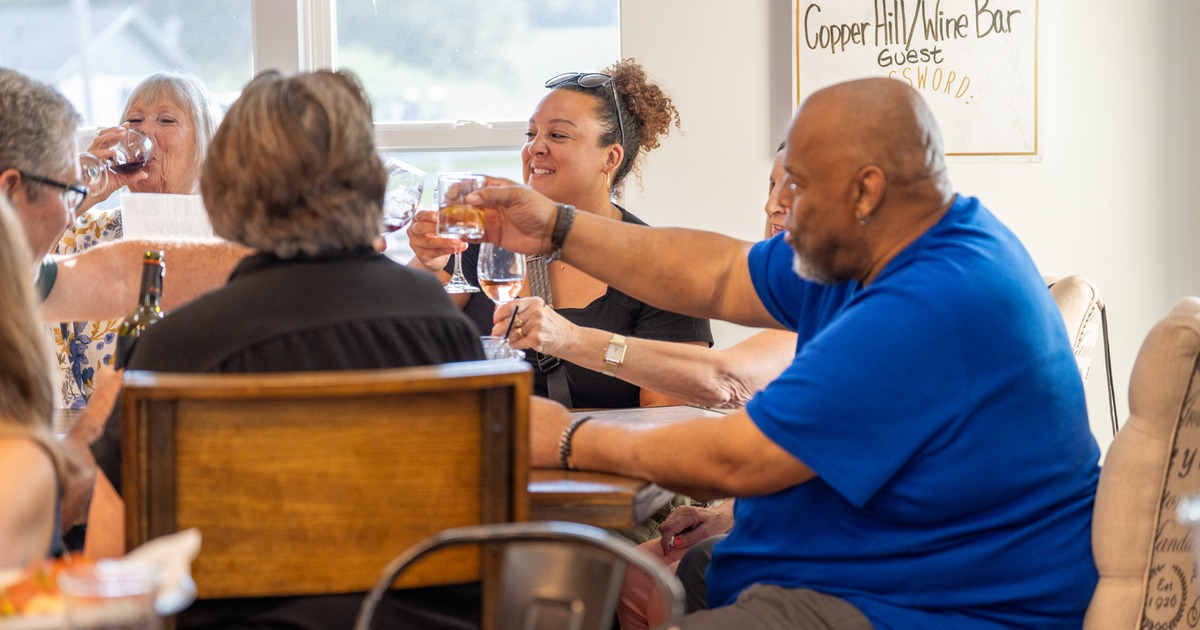 Diner table, happy people are toasting at the table