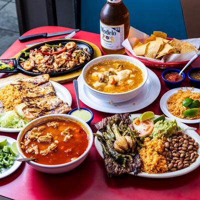 Assorted food dishes on a red table.