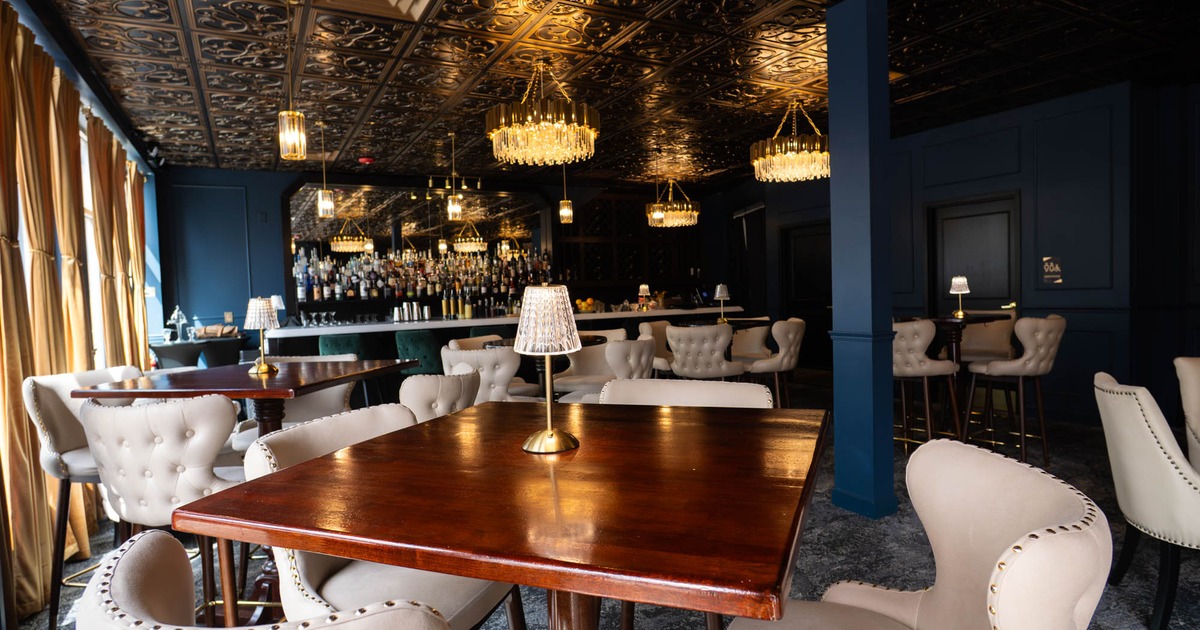 Elegant interior with tufted chairs and chandeliers