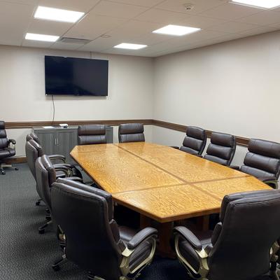 A large meeting table and office armchairs around it.
