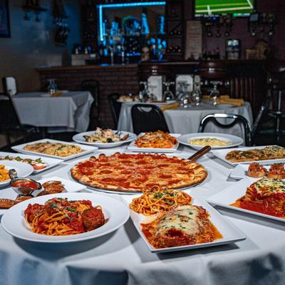Restaurant interior, a plethora of food displayed on a table.