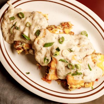 Savory dish topped with creamy gravy and green onions.