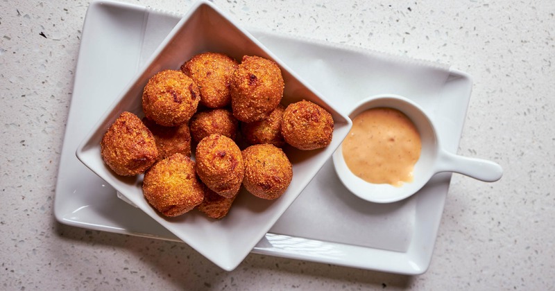 Hush puppies with a sauce dip, top view