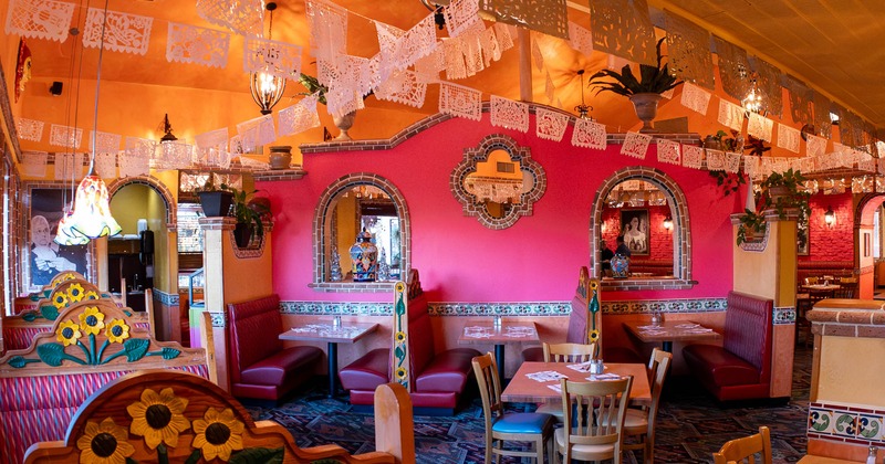 Interior, dining area, seating booths with tables, Mexican motif decoration