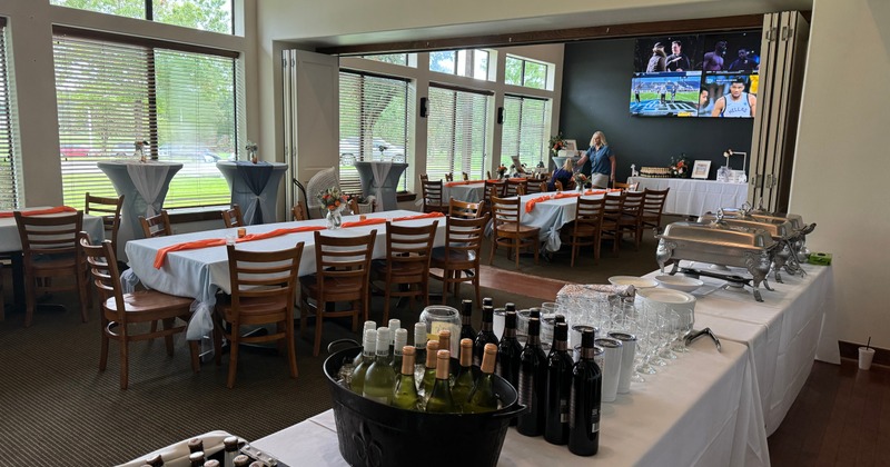 Banquet room with set tables and a buffet