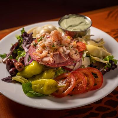 Antipasto salad, with lettuce, tomato, olives, peppers, ceviche, red onion and pepperoni