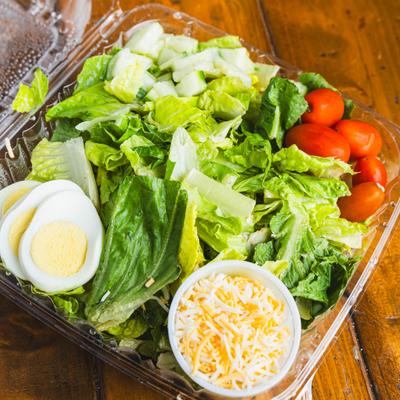 Garden Salad with shredded cheese, cherry tomato, egg, and cucumber.