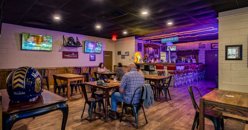 Interior, bar and seating area with guests