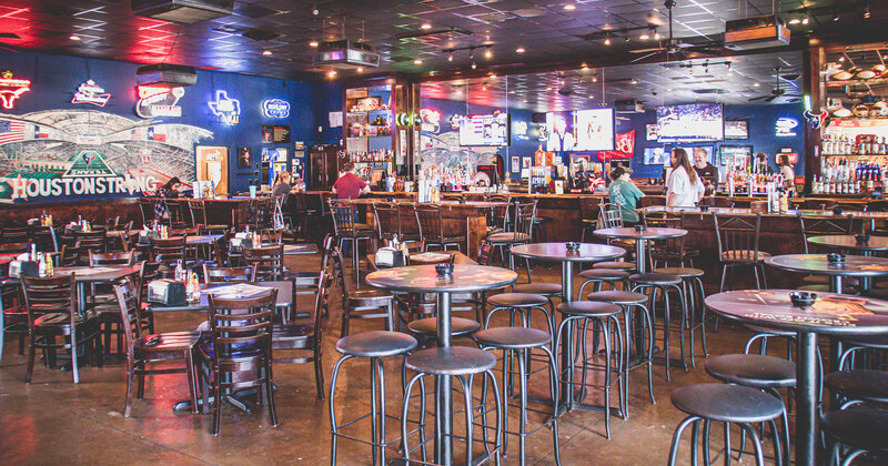 Interior, main seating area with tall round tables and chairs