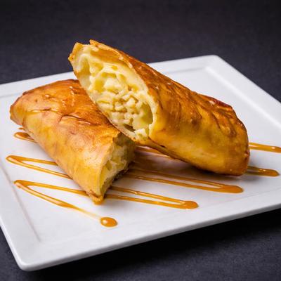 Chimi Cheesecake drizzled with caramel sauce.