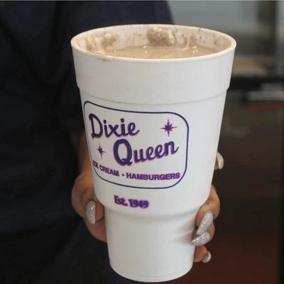 Hand holding a milkshake.