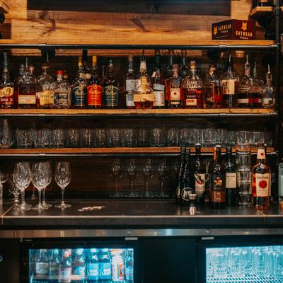 Liquor bottles and glassware on the shelves.