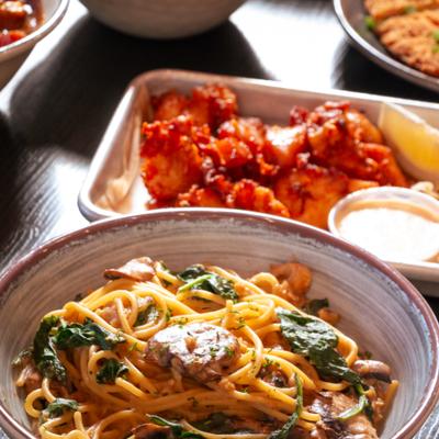 Spinach And Mushroom Spaghetti and a plate of fried sake-marinated chicken.