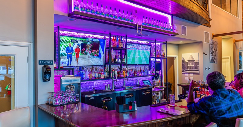 Interior, bar, stools, tv screens, drink rack