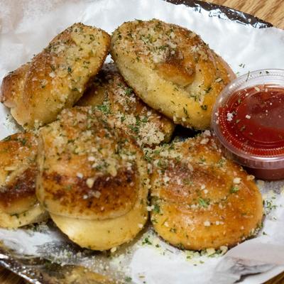 Garlic knots topped with parsley and parmesan, served with a side of marinara.