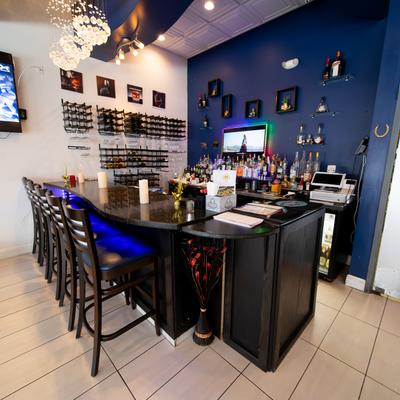 Interior,  a bar with a wall wine rack and spirits.