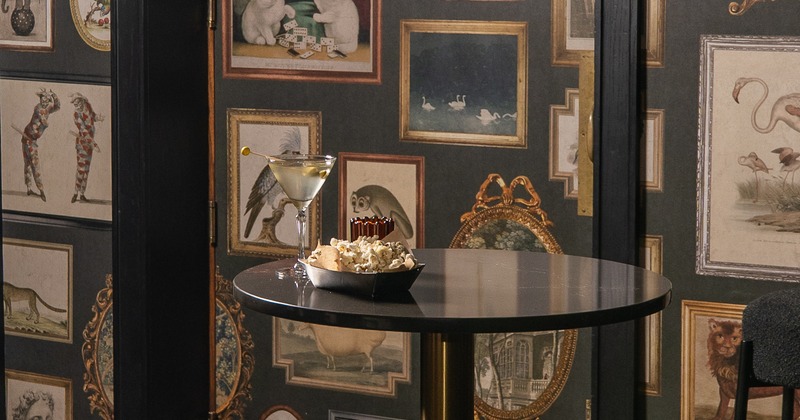 Bar table, stools, wall with art paintings