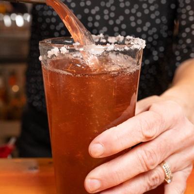 Bartender pouring a cocktail.