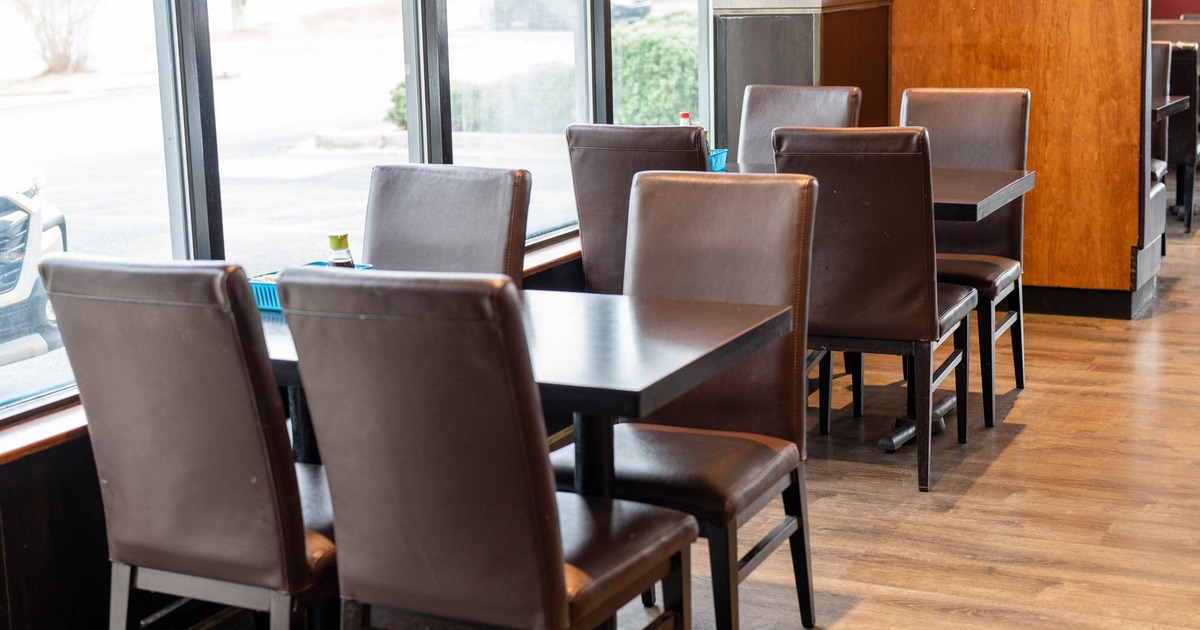 Interior, dining tables and chairs by the windows