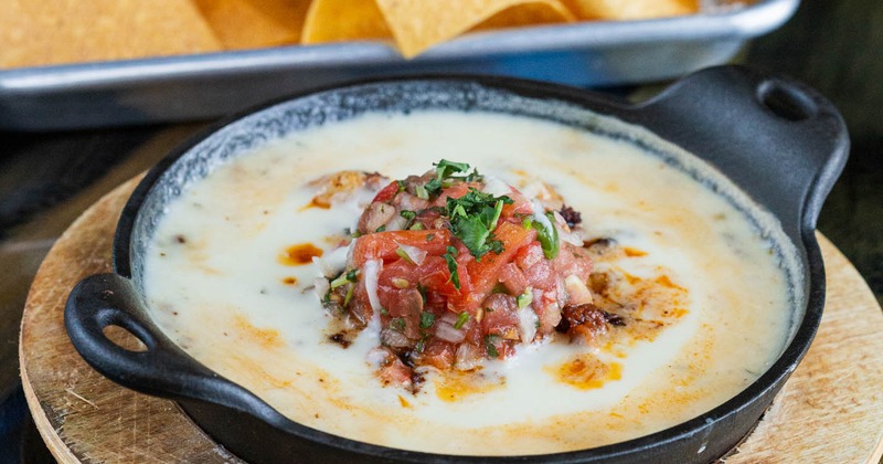 Cheese dip, mixed with chorizo, grilled shrimp, and pico de gallo, with tortilla chips on the side